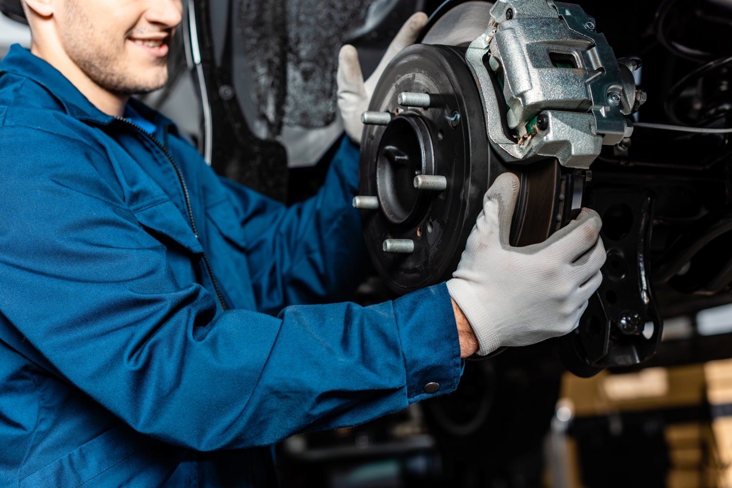 Technician performing brake service on a vehicle at DriveTime Automotive in Salem, OR.