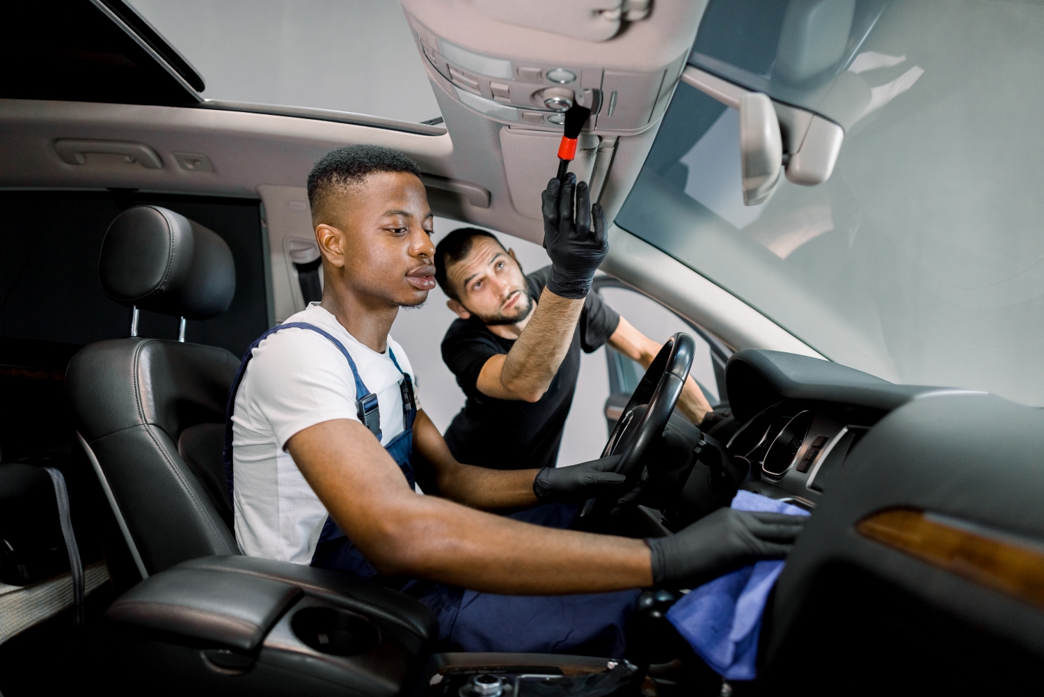 Technician performing scheduled maintenance on a car at DriveTime Automotive in Salem, OR.