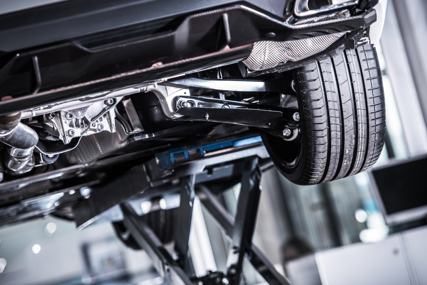 Technician inspecting and repairing a car's suspension system at DriveTime Automotive in Salem, OR.