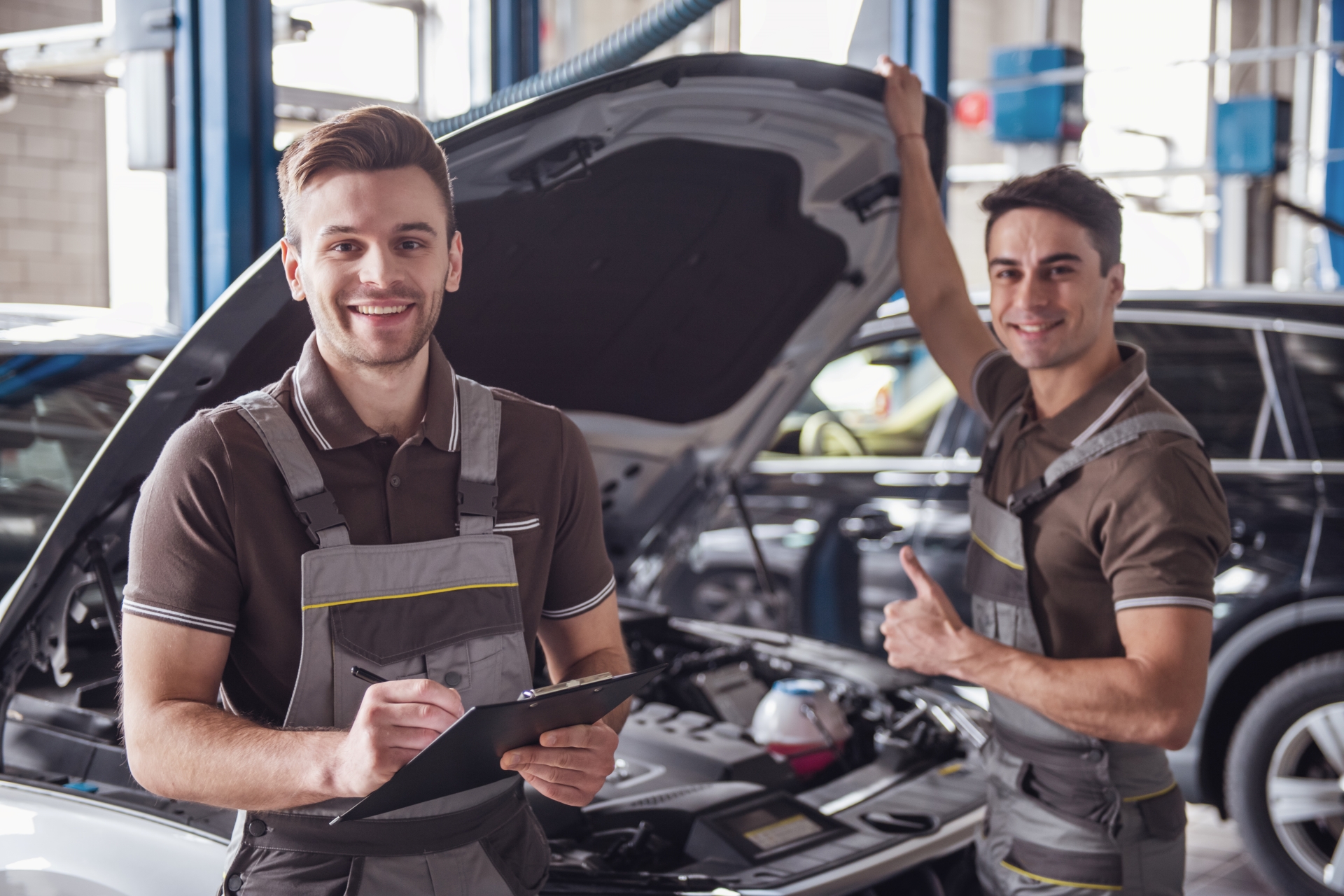 Automotive service technicians working on a car